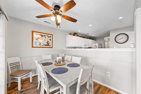 Dining set with 8 chairs, sliding doors to screened-in porch.