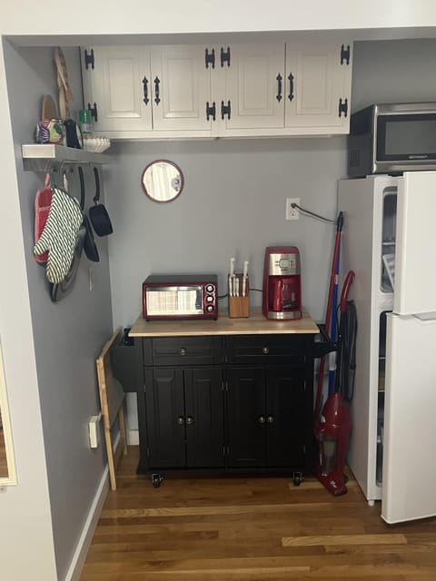 Cozy kitchenette with modern appliances and warm wood floors