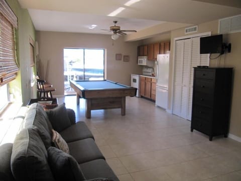 1st floor living room area with queen sized bed and bathroom with shower