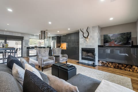 Living Room with Comfortable Modern Furnishings and Large Flat Screen TV and Apple TV. Fireplace is Not Operational