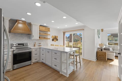 Your spacious kitchen flows seamlessly into the living area, featuring modern appliances and a breakfast island perfect for morning coffee.