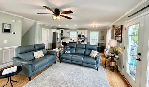 Living area with new sofas and remodeled kitchen