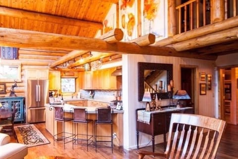 Kitchen with large Humming Bird water color paintings above.