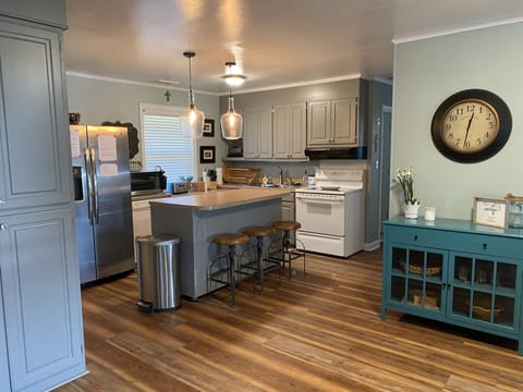 Kitchen with island eating area.  Microwave, ice maker, dishwasher, coffee maker