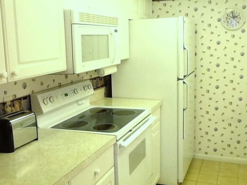 Everything conveniently at hand. Lots of kitchen utensils, dishes & glasses.