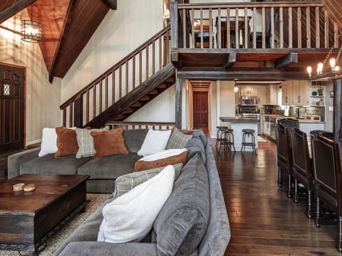 Great room with comfortable couch, big screen TV and fireplace