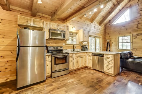 The fully stocked kitchen features granite countertops and an electric range.