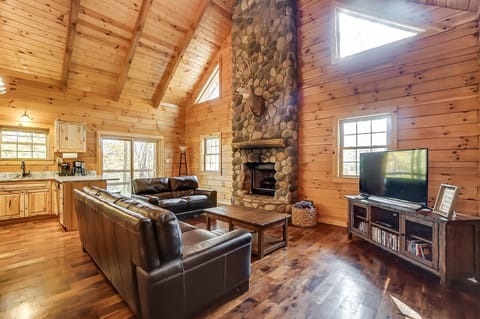 The open floor plan features living room with smart TV, cable and gas fireplace.