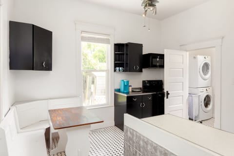 Looking into kitchen and separate laundry room.  Banquette seats 4 in kitchen.