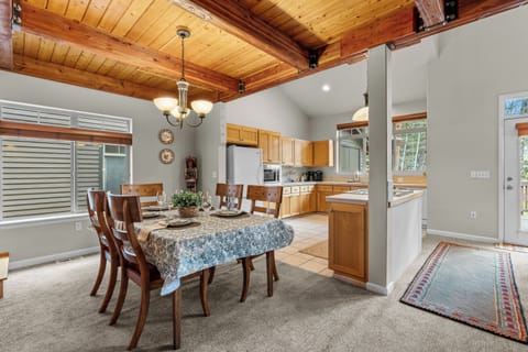 Gather around your inviting dining space, where warm wood ceilings and abundant natural light create the perfect setting for shared meals and memorable conversations with loved ones.