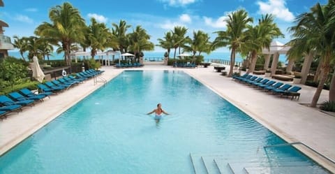 Upper pool with lush landscaping, a tropical oasis.