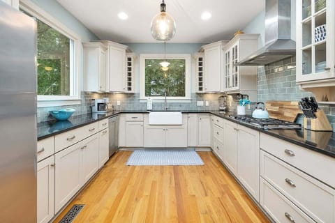 Kitchen with wood floors and white cabinets
