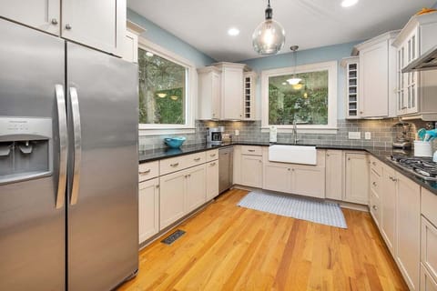 Kitchen with white cabinets and wood floors