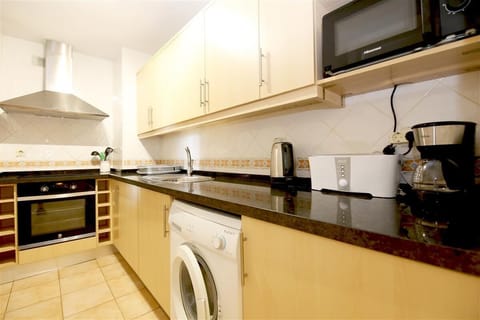 Kitchen in this apartment is fully equipped with all the appliances