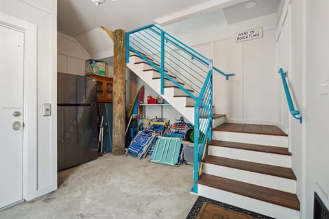 Extra full fridge in main entrance, with plenty of beach chairs.