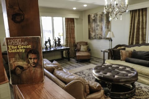 'The Great Gatsby' living room with a stone fireplace and 70" tv.