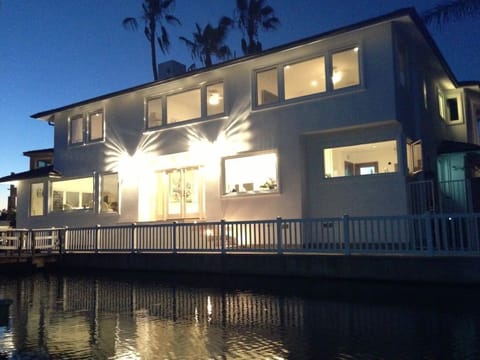Enjoy 128 feet of water frontage on Newport Harbor in a gated neighborhood.