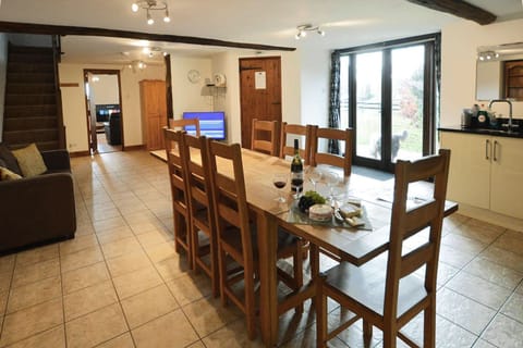 Ground floor: Dining and family area with a TV and sofa in the open plan living space