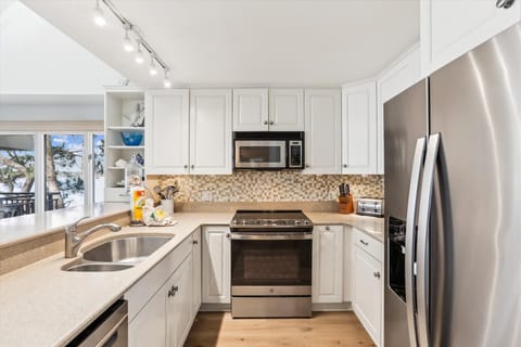 Kitchen with Stainless Steel Appliances at 1883 Beachside Tennis
