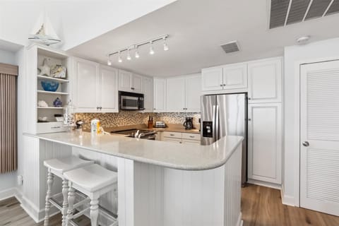 Kitchen with Breakfast Counter at 1883 Beachside Tennis