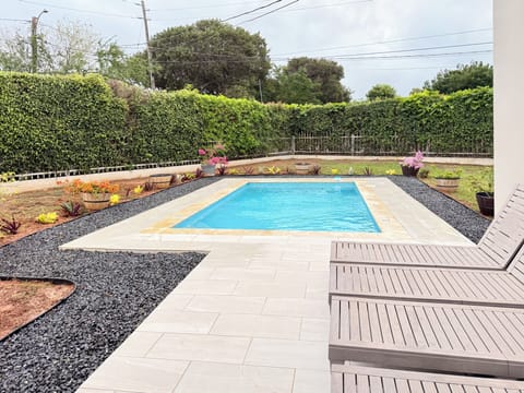 Private swimming pools with lounge chairs.