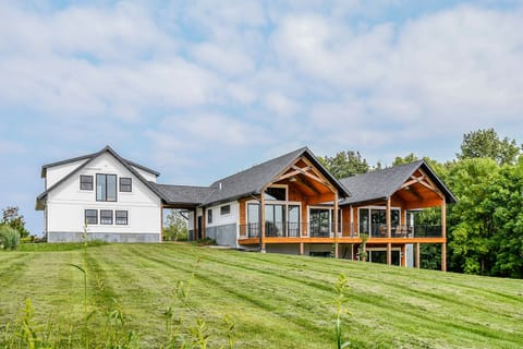 Exterior lakeside with large lawn overlooking lake.