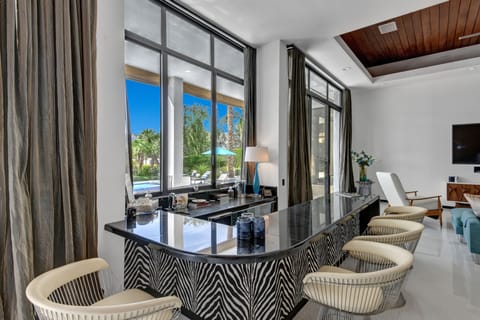 Interior and exterior bar with sink, sliding windows to serve outdoor guest.