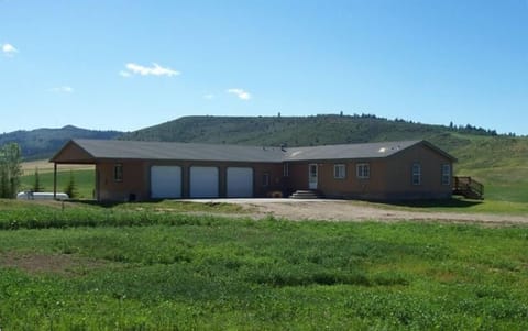 Rear view of Aspen Hills Retreat, showing garages and parking area
