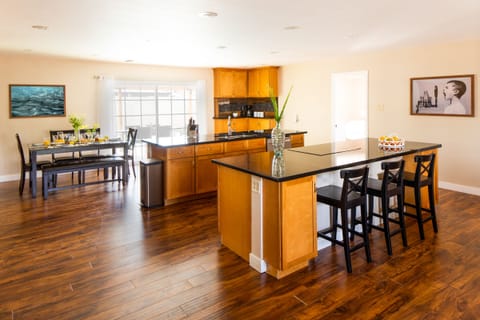 Open concept kitchen features two islands and a dining area.