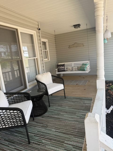 Charming front porch with bistro set and swing to enjoy coffee or a cocktail