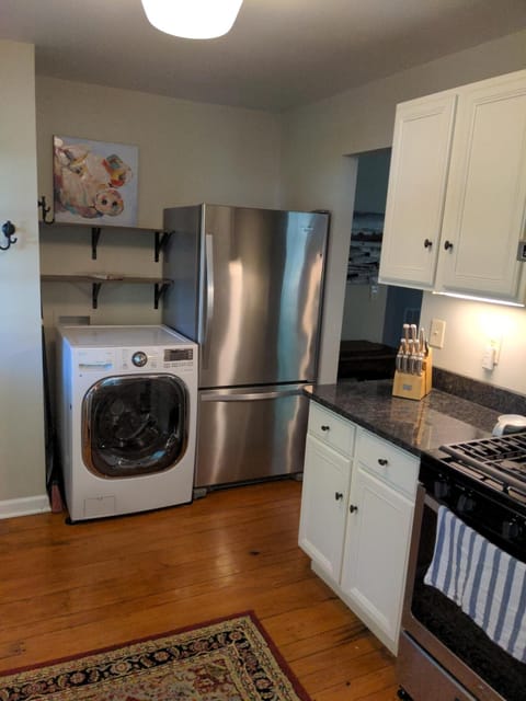 Update photo with added hooks and shelves above washer/dryer combo.