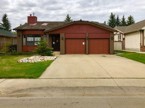Street view of front of house and large driveway for parking 
