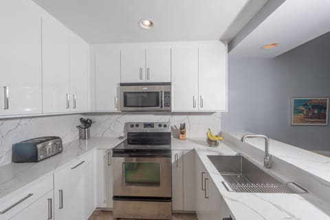 New kitchen has coffee maker, microwave, stove/oven, & dishwasher. 
