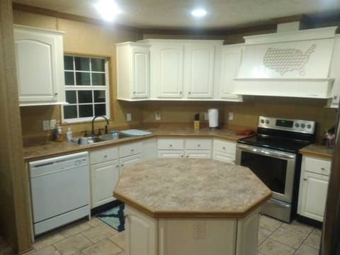 Fully equipped kitchen with pots, pans, and dinnerware