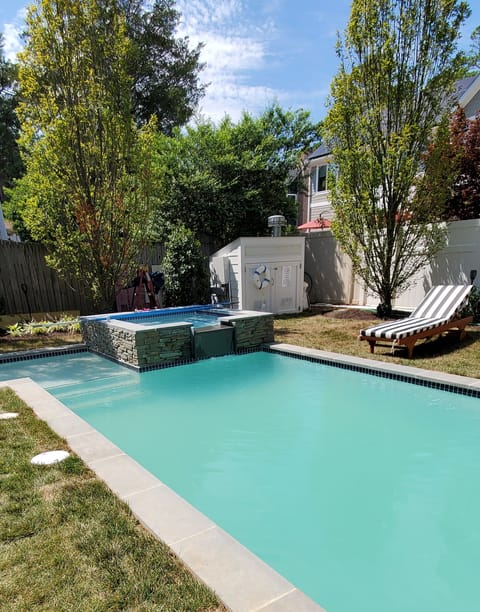 Custom heated pool with raised spa and shallow bubbler splash pad!