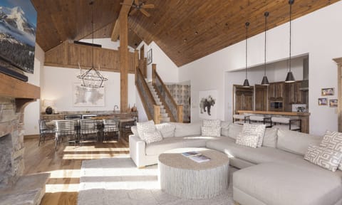 Unwind in this stunning open-concept space where rustic wood meets modern comfort. Sink into plush seating while soaking up the warmth from your stone fireplace.