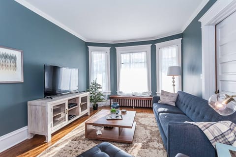 Large living room with cable television and plenty of natural light. 