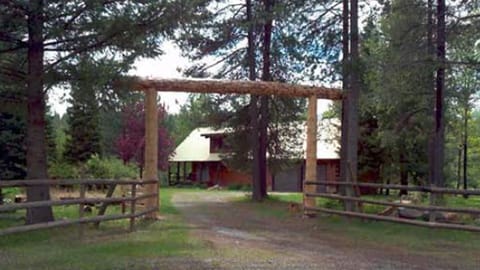 Gate from road.  Some trees are missing due to wind storms last year
