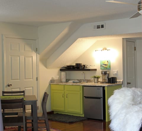 Kitchenette with sink, microwave, coffeemaker, toaster, and fridge.