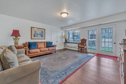 Living room with doors that lead to the fenced-in backyard