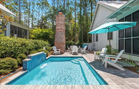 Picture yourself relaxing poolside under the shade, surrounded by towering pines. Your private oasis features a sparkling pool, cozy seating by the brick fireplace, and plenty of sunny spots to unwind.