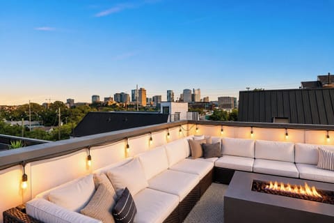 Your private rooftop at golden hour — fire pit glowing, wine on ice, and the Nashville skyline waiting on you.
