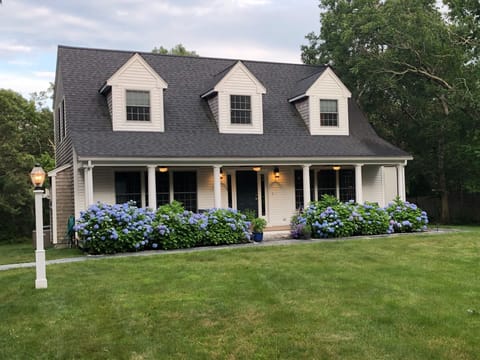 Front yard and porch of Katama Winds.  Enjoy our Adirondack seating.