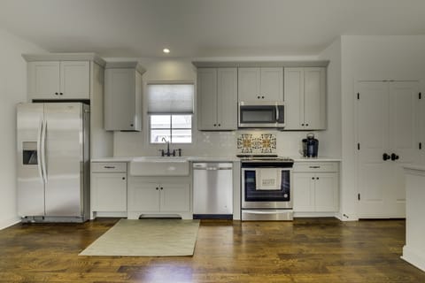 Kitchen is fully equipped with stainless steel appliances and a farm sink.