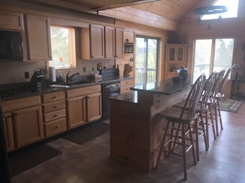 Kitchen has full refrigerator plus drink cooler in island 