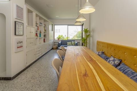 Living room with beautiful dining table,  comfortable lighting, and library