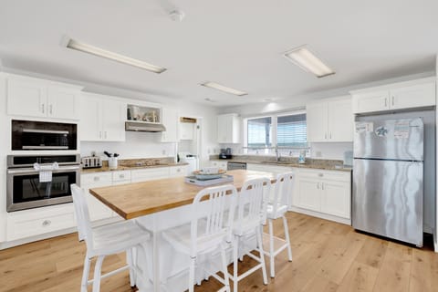 The kitchen is fully equipped and offers bar seating at the island