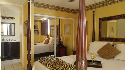 Very comfortable 4 poster queen bed, view to bathroom. Mirrored closet