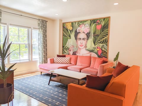 Goregous Frida wall hanging in the living room with sleeper sofa on right.