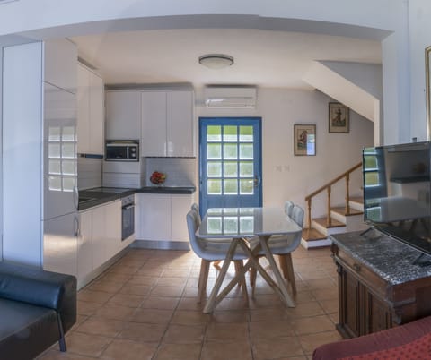 View from living room towards kitchen and stairs leading to second floor